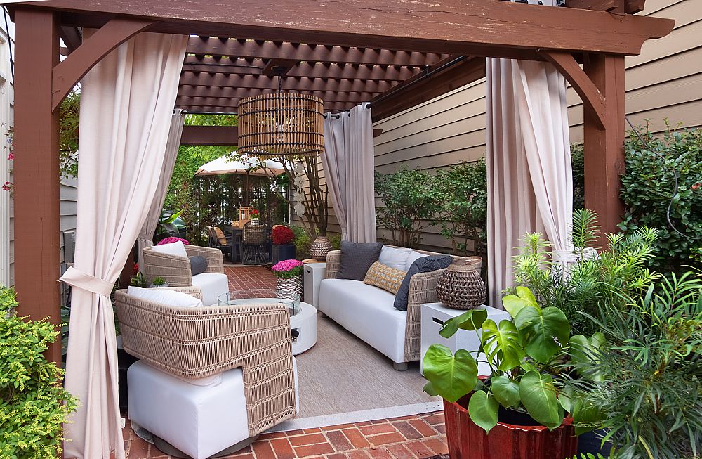 Covered patio with shade features and outdoor seating.